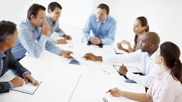 People at a table at a meeting.