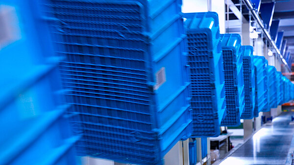 Blue containers on assembly line