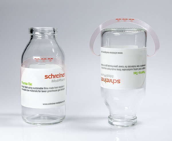 Pharma-Tac label for infusion bottles with integrated hanger as environmentally friendly label