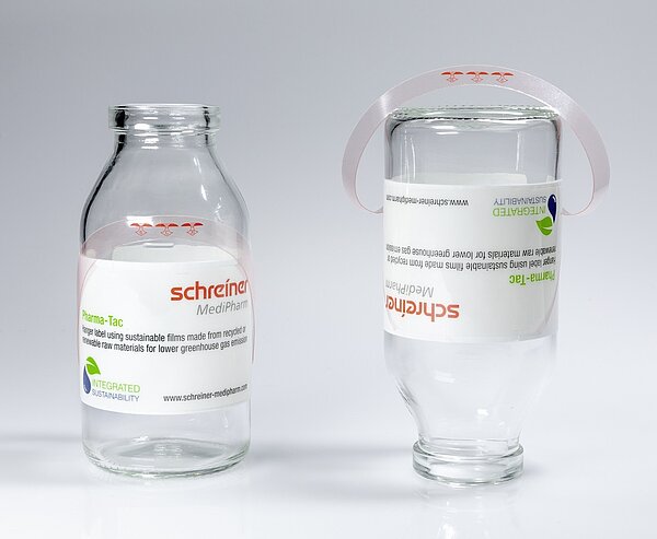 Pharma-Tac label for infusion bottles with integrated hanger as environmentally friendly label